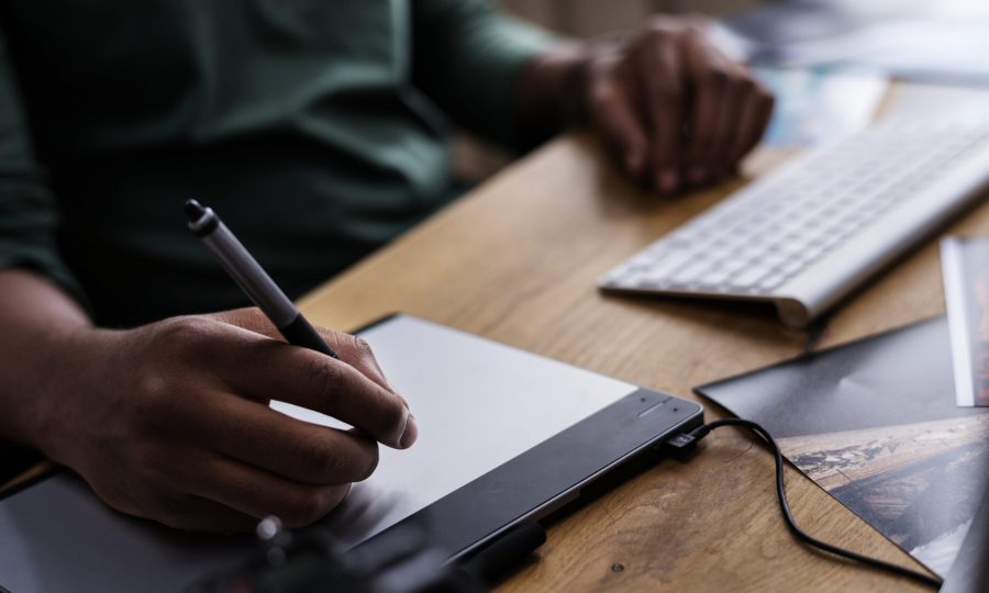 Close up of people's hand working on computer